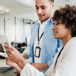 Two professionals engaging in collaborative work in a contemporary office setting.